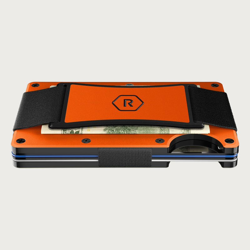 Ridge wallet in orange with black cash strap and elastic band, folded cash tucked underneath, front angle view.